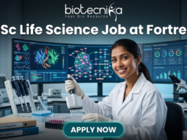 Urgent Hiring! BSc Life Science Job at Fortrea | Opportunity You Shouldn’t Miss BSc Life Science Job at Fortrea Opportunity You Shouldn’t Miss. A promotional featured image for a job page. At the top, text reads: "biotecnika Your Bio Resource" and the headline "BSc Life Science Job at Fortrea". The image depicts a smiling female scientist of Indian heritage, in a white lab coat and nitrile gloves, using a multichannel pipette to work with a 96-well plate at a modern laboratory bench. The background features three large, curved monitors displaying complex data visualizations like protein structures, molecular pathways, and generic clinical trial progress charts. Foreground elements include binders labeled "Clinical Studies" and "R&D reports", microcentrifuge tubes, and multiple pipettes. At the bottom center is a teal "APPLY NOW" button.