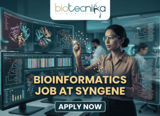 Dream Bioinformatics Job at Syngene | Associate Scientist Role You Can’t Miss! A high-tech promotional graphic for a Bioinformatics Job at Syngene, featuring the Biotecnika logo at the top. The image depicts a female scientist in a professional office setting, using a digital stylus to interact with glowing, transparent holographic screens. These displays show complex biological data, including 3D molecular protein structures, genetic heatmaps, and phylogenetic trees. In the background, a modern laboratory with other researchers is visible. The central text reads "BIOINFORMATICS JOB AT SYNGENE" in bold gold lettering, with a dark blue "APPLY NOW" button located at the bottom center.
