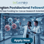 CRI Irvington Postdoctoral Fellowship 2026: Up to $78,000/Year Funding for Cancer Research Scientists Worldwide A high-tech promotional graphic for the CRI Irvington Postdoctoral Fellowship 2026, featuring the Biotecnika logo at the top. The main headline reads "CRI Irvington Postdoctoral Fellowship 2026" with a sub-headline: "Up to $78,000/Year Funding for Cancer Research Scientists Worldwide." In a futuristic, dimly lit laboratory with a night-time city skyline visible through floor-to-ceiling windows, two scientists—a woman and a man in white lab coats—interact with a large, glowing cyan holographic interface. The display shows a detailed 3D model titled "Targeted Neutralization of Cancer Cells" alongside a world map labeled "Worldwide Collaborative Data," symbolizing global research impact. At the bottom center, a prominent dark teal "Apply Now" button stands out against the sleek laboratory environment.