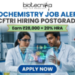 Biochemistry Job Alert! CSIR-CFTRI Hiring Postgraduates | Earn ₹28,000 + 20% HRA CSIR-CFTRI Hiring for Biochemistry Job Earn Upto ₹28,000. A professional and vibrant featured image advertisement for a biochemistry job alert at CSIR-CFTRI, created for Biotecnika. The scene features two young scientists (a man and a woman) in white lab coats and safety goggles, intensely discussing a holographic 3D molecular structure displayed over a lab bench. The background is a brightly lit, modern food science laboratory equipped with advanced bioreactors and analytical instruments. The Biotecnika logo is at the top center. The main text reads "BIOCHEMISTRY JOB ALERT! CSIR-CFTRI HIRING POSTGRADUATES" with a gold ribbon tagline below stating "Earn ₹28,000 + 20% HRA." A large, blue "APPLY NOW" button is positioned at the bottom.