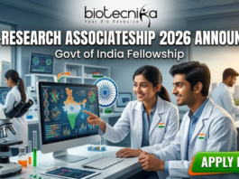 DBT-Research Associateship 2026 Govt of India Fellowship. A promotional featured image for the "DBT-Research Associateship 2026" Government of India Fellowship. The graphic shows two scientists in white lab coats working in a high-tech laboratory, looking at a computer screen displaying scientific data and a map of India. The Biotecnika logo is at the top, with the announcement text in the center and a prominent "APPLY NOW" button at the bottom right.