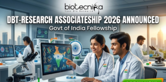 DBT-Research Associateship 2026 Govt of India Fellowship. A promotional featured image for the "DBT-Research Associateship 2026" Government of India Fellowship. The graphic shows two scientists in white lab coats working in a high-tech laboratory, looking at a computer screen displaying scientific data and a map of India. The Biotecnika logo is at the top, with the announcement text in the center and a prominent "APPLY NOW" button at the bottom right.