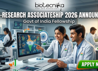 DBT-Research Associateship 2026 Announced – Govt of India Fellowship for Life Science Researchers! DBT-Research Associateship 2026 Govt of India Fellowship. A promotional featured image for the "DBT-Research Associateship 2026" Government of India Fellowship. The graphic shows two scientists in white lab coats working in a high-tech laboratory, looking at a computer screen displaying scientific data and a map of India. The Biotecnika logo is at the top, with the announcement text in the center and a prominent "APPLY NOW" button at the bottom right.
