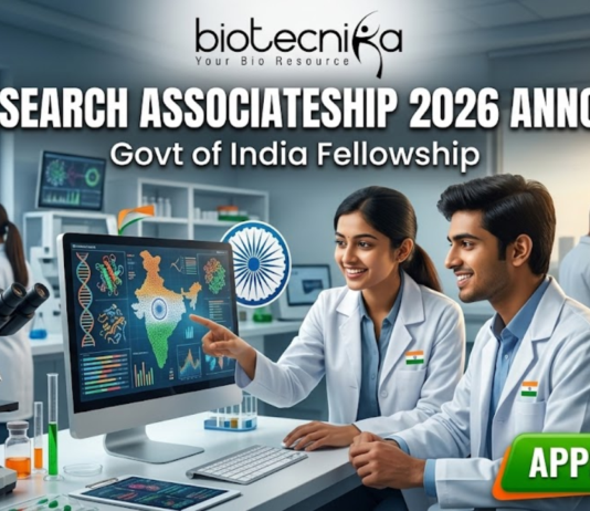 DBT-Research Associateship 2026 Govt of India Fellowship. A promotional featured image for the "DBT-Research Associateship 2026" Government of India Fellowship. The graphic shows two scientists in white lab coats working in a high-tech laboratory, looking at a computer screen displaying scientific data and a map of India. The Biotecnika logo is at the top, with the announcement text in the center and a prominent "APPLY NOW" button at the bottom right.