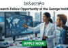 Research Fellow at George Institute | Fresher's Job India. A professional featured job image with the Biotecnika logo at the top and a bold headline reading "Research Fellow Opportunity at the George Institute." The central scene features a female scientist in a white lab coat pointing to a large digital monitor displaying global health maps, data analytics, and chronic disease trends, while a male colleague looks on. The setting is a modern, high-tech laboratory equipped with a microscope and glassware. At the bottom center, there is a prominent green "APPLY NOW" button.