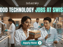 Exciting Food Technology Jobs Alert at Swish | Don't Miss This Opporunity. A unique and futuristic featured image for "Food Technology Jobs at Swish." Two scientists in a high-tech food lab are examining a glowing, layered "tech-food" sample. The lab is equipped with 3D food printers and robotic arms. The Biotecnika logo is at the top, and a clean "Apply Now" button with an arrow is at the bottom center.