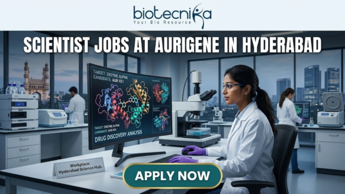 Scientist Jobs at Aurigene in Hyderabad Scientist Jobs at Aurigene in Hyderabad. A high-quality, professional featured image for "Scientist Jobs at Aurigene in Hyderabad." The scene depicts a female scientist in a white lab coat and purple gloves working in a sophisticated laboratory. She is focused on a large monitor displaying vibrant 3D molecular structures under the heading "Drug Discovery Analysis." Her desk features a modern microscope and a small plaque that says "Workplace: Hyderabad Science Hub." In the background, the iconic Charminar is visible through a large window, establishing the Hyderabad setting. The Biotecnika logo is positioned at the top center, the job title is in bold white lettering, and a prominent "APPLY NOW" button is at the bottom.