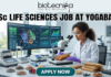 BSc Life Sciences Job at Yogabar Careers | Apply Now. A high-quality, professional featured image for a "BSc Life Sciences Job at Yogabar." The scene depicts a female food scientist in a white lab coat and safety goggles in a bright, modern food science laboratory. She is carefully examining a healthy snack bar under a professional microscope. On her desk are raw ingredients like chia seeds, flax seeds, and berries, alongside advanced lab equipment like a moisture analyzer. A large computer monitor in the background displays complex "Nutritional Profile Analysis" and 3D protein structures. The Biotecnika logo is at the top, the main job title is in bold black text, and a prominent "APPLY NOW" button is at the bottom.