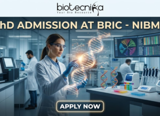 PhD Admission At BRIC - NIBMG | Fully Funded Research. A sleek, high-tech professional featured image for "PhD Admission At BRIC - NIBMG." The image features a focused female researcher in a white lab coat and safety glasses, interacting with a glowing, holographic 3D DNA helix in a modern genomic laboratory. The background shows other scientists working with advanced sequencing equipment and large curved monitors displaying genomic mapping data. The Biotecnika logo is at the top center, the main title is in elegant gold and white lettering, and a glowing "APPLY NOW" button is positioned at the bottom.