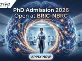 PhD Admission 2026 Open at BRIC-NBRC | Apply Online Today. A featured image for PhD Admission 2026 at BRIC-NBRC. The image shows a female scientist in a white lab coat standing in a futuristic laboratory, surrounded by a large, glowing holographic human brain with intricate neural pathways. The text "PhD Admission 2026 Open at BRIC-NBRC" is prominently displayed at the top center. The Biotecnika logo is in the top left corner, and a blue "APPLY NOW" button is positioned at the bottom. Background researchers work in a high-tech neurobiology research environment.
