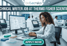 Technical Writer Job at Thermo Fisher Scientific | Latest Life Science Job Opportunities Technical Writer Job at Thermo Fisher Scientific | Life Science Job. Featured image for a Technical Writer job vacancy at Thermo Fisher Scientific. The realistic visual features a professional female scientist in a white lab coat and safety glasses diligently working on a laptop within a high-tech, modern laboratory filled with advanced scientific equipment and monitors. The top of the image displays the Biotecnika logo and the bold text 'TECHNICAL WRITER JOB AT THERMO FISHER SCIENTIFIC,' while a prominent, glowing 'APPLY NOW' button is positioned at the bottom center.