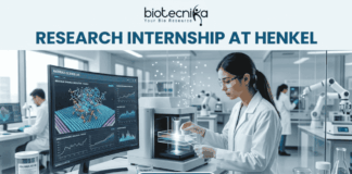 Research Internship at Henkel for MSc Biochemistry & Biotechnology Candidates | Apply Now! A professional featured image for a 'Research Internship at Henkel.' The visual shows a female scientist in a white lab coat and safety goggles working in a high-tech, modern laboratory. She is operating advanced analytical equipment while a large monitor in the background displays colorful 3D molecular simulations. The Biotecnika logo is placed at the top, and a prominent 'Apply Now' button is located at the bottom center.