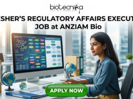 Fresher Regulatory Affairs Executive Job at ANZIAM Bio Apply. A recruitment poster for a "Fresher’s Regulatory Affairs Executive Job at ANZIAM Bio," featuring a young professional woman concentrating on a large computer monitor in a modern open-plan office with a cityscape view through the windows. The logo "biotecnika Global tagling technolgies" is at the top. On her desk, colorful files with labels like "Global Reg Guidelines," "EU Submission," and "ANZ Submission Protocols" are stacked, along with two globes. The computer screen shows regulatory pathways and charts. At the bottom center, a prominent green button reads "APPLY NOW".
