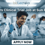Clinical Trial Job Alert: Freshers Wanted at Sun Pharma – Start Your Clinical Research Career Today! Freshers Clinical Trial Job at Sun Pharma | Don't Miss It. A featured image for a job posting titled "Freshers Clinical Trial Job at Sun Pharma" in a $1280 \times 720$ format.The image depicts a modern, high-tech laboratory setting where a young, smiling male scientist in a white lab coat is working with a pipette and a multi-well plate. A transparent digital holographic display in front of him shows "Clinical Trial Data" with various charts and graphs. In the background, other researchers are visible in a clean, professional clinical environment.The Biotecnika logo is positioned clearly at the top center, and a prominent, rounded "APPLY NOW" button is located at the bottom center. The overall aesthetic is professional, bright, and engaging.