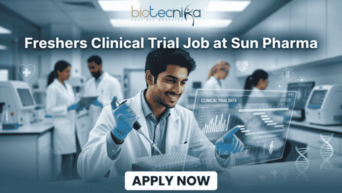 Freshers Clinical Trial Job at Sun Pharma Don't Miss It Freshers Clinical Trial Job at Sun Pharma | Don't Miss It. A featured image for a job posting titled "Freshers Clinical Trial Job at Sun Pharma" in a $1280 \times 720$ format.The image depicts a modern, high-tech laboratory setting where a young, smiling male scientist in a white lab coat is working with a pipette and a multi-well plate. A transparent digital holographic display in front of him shows "Clinical Trial Data" with various charts and graphs. In the background, other researchers are visible in a clean, professional clinical environment.The Biotecnika logo is positioned clearly at the top center, and a prominent, rounded "APPLY NOW" button is located at the bottom center. The overall aesthetic is professional, bright, and engaging.