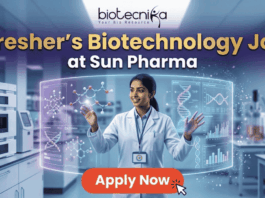Fresher’s Job Alert! Biotechnology Job at Sun Pharma | Don’t Miss Out! Fresher's Job Alert! Biotechnology Job at Sun Pharma Don’t Miss Out! A promotional job banner with the Biotecnika logo at the top. The headline text is "Fresher's Biotechnology Job" and "at Sun Pharma". A smiling young woman in a lab coat stands in a futuristic laboratory, interacting with floating holographic screens. The screens display molecular structures labeled "Drug Discovery" and "Lead Identification," and a DNA helix with graphs labeled "DNA" and "Data Discovery". A large red button at the bottom says "Apply Now". The background shows complex lab equipment.