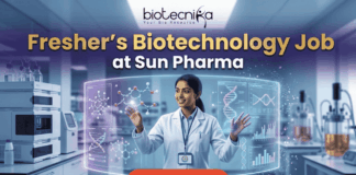 Fresher’s Job Alert! Biotechnology Job at Sun Pharma | Don’t Miss Out! Fresher's Job Alert! Biotechnology Job at Sun Pharma Don’t Miss Out! A promotional job banner with the Biotecnika logo at the top. The headline text is "Fresher's Biotechnology Job" and "at Sun Pharma". A smiling young woman in a lab coat stands in a futuristic laboratory, interacting with floating holographic screens. The screens display molecular structures labeled "Drug Discovery" and "Lead Identification," and a DNA helix with graphs labeled "DNA" and "Data Discovery". A large red button at the bottom says "Apply Now". The background shows complex lab equipment.