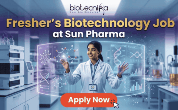 Fresher’s Job Alert! Biotechnology Job at Sun Pharma | Don’t Miss Out! Fresher's Job Alert! Biotechnology Job at Sun Pharma Don’t Miss Out! A promotional job banner with the Biotecnika logo at the top. The headline text is "Fresher's Biotechnology Job" and "at Sun Pharma". A smiling young woman in a lab coat stands in a futuristic laboratory, interacting with floating holographic screens. The screens display molecular structures labeled "Drug Discovery" and "Lead Identification," and a DNA helix with graphs labeled "DNA" and "Data Discovery". A large red button at the bottom says "Apply Now". The background shows complex lab equipment.