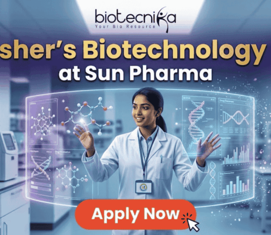 Fresher's Job Alert! Biotechnology Job at Sun Pharma Don’t Miss Out! A promotional job banner with the Biotecnika logo at the top. The headline text is "Fresher's Biotechnology Job" and "at Sun Pharma". A smiling young woman in a lab coat stands in a futuristic laboratory, interacting with floating holographic screens. The screens display molecular structures labeled "Drug Discovery" and "Lead Identification," and a DNA helix with graphs labeled "DNA" and "Data Discovery". A large red button at the bottom says "Apply Now". The background shows complex lab equipment.