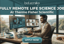Fully Remote Life Science Job at Thermo Fisher Scientific – Global Opportunity! Fully Remote Life Science Job at Thermo Fisher Scientific – Global Opportunity! A professional, attractive, and unique featured image for a "Fully Remote Life Science Job At Thermo Fisher Scientific," recruited through biotecnika. A smiling South Asian man with headphones types on a laptop at a large wooden desk in a bright home office. His desk features monitors displaying 3D molecular structures, data charts, and a group video conference call. Automated lab equipment and reagent tubes are on the desk. A large window overlooks a scenic mountainous view, with a tabby cat asleep nearby. Header text reads 'FULLY REMOTE LIFE SCIENCE JOB At Thermo Fisher Scientific'. The 'biotecnika Your Bio Resource' logo is at the top. A prominent 'APPLY NOW' button is at the bottom center. No Thermo Fisher Scientific company logo graphic is present.