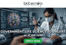 Government Life Science Job Alert 2026 – Earn Upto ₹56,000 + HRA as Research Scientist at ICAR-IVRI! Government Life Science Job Alert 2026 – Earn Upto ₹56,000 + HRA as Research Scientist at ICAR-IVRI!. Professional featured image for a "Government Life Science Job Alert at ICAR-IVRI" advertisement. The image depicts a female scientist in a white lab coat and protective gear using a pipette in a high-tech laboratory setting. A large computer monitor in the background displays detailed 3D pathogen genomics and vaccine development data. The layout features the Biotecnika logo at the top and a prominent green "APPLY NOW" button at the bottom center.