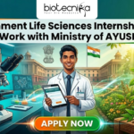 Government Life Sciences Internship 2026 at CCIH | Work with Ministry of AYUSH Government Life Sciences Internship 2026 Work with Ministry of AYUSH. A featured image for Biotecnika Global promoting a "Government Life Sciences Internship 2026: Work with Ministry of AYUSH." The graphic features a young male scientist in a white lab coat standing at the center, holding a digital tablet. The background is a vibrant blend of modern biotechnology—showing molecular models and lab equipment—and traditional Indian medicine, featuring medicinal herbs, a Tulsi plant, and a stone mortar and pestle. In the distance, a grand government building flies the Indian national flag. The top of the image displays the Biotecnika logo, and a prominent orange "APPLY NOW" button is centered at the bottom.