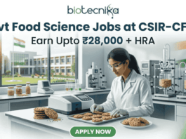 "Govt Food Science Jobs at CSIR-CFTRI | Earn Upto ₹28K+ HRA. A professional featured image for a 'Govt Food Science Jobs at CSIR-CFTRI' recruitment page. It depicts an Indian female scientist in a modern laboratory inspecting food samples (cookies). The image includes the Biotecnika logo at the top, a salary tagline 'Earn Upto ₹28,000 + HRA', and a prominent green 'Apply Now' button at the bottom."