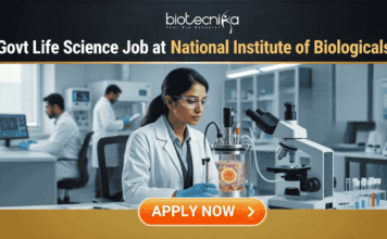 Govt. Life Science Job Alert 2026 at National Institute of Biologicals | Apply Now Govt Life Science Job Alert 2026 at National Institute of Biologicals. A professional featured image for a "Govt Life Science Job at National Institute of Biologicals." It shows a scientist in a clean, modern laboratory setting operating a bioreactor. The design features a prominent Biotecnika logo at the top, the Indian national emblem (Satyameva Jayate) in a frame on the desk, and a bright orange "Apply Now" button at the bottom.