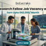 High Paying Senior Research Fellow Job Vacancy at NIFTEM Earn Upto ₹42,000 Month. A professional and vibrant featured image for a "Senior Research Fellow Job Vacancy at NIFTEM." The scene showcases three diverse researchers in white lab coats working in a sunlit, state-of-the-art food technology laboratory. They are gathered around an advanced imaging device analyzing a 3D-rendered food sample. A large digital monitor in the background displays complex data visualizations and structural models. The Biotecnika logo is positioned at the top center. The primary text reads "Senior Research Fellow Job Vacancy at NIFTEM" with a sub-headline "Earn Upto ₹42,000/ Month." A sleek, glowing "APPLY NOW" button is located at the bottom.