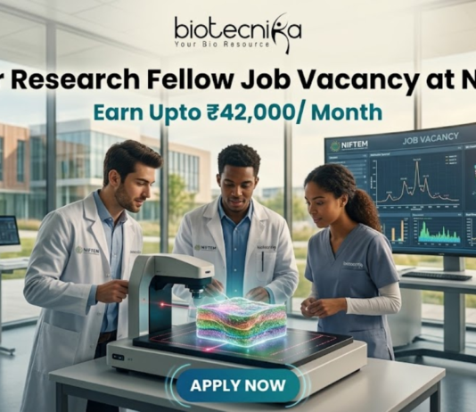 High Paying Senior Research Fellow Job Vacancy at NIFTEM | Earn Upto ₹42,000/ Month High Paying Senior Research Fellow Job Vacancy at NIFTEM Earn Upto ₹42,000 Month. A professional and vibrant featured image for a "Senior Research Fellow Job Vacancy at NIFTEM." The scene showcases three diverse researchers in white lab coats working in a sunlit, state-of-the-art food technology laboratory. They are gathered around an advanced imaging device analyzing a 3D-rendered food sample. A large digital monitor in the background displays complex data visualizations and structural models. The Biotecnika logo is positioned at the top center. The primary text reads "Senior Research Fellow Job Vacancy at NIFTEM" with a sub-headline "Earn Upto ₹42,000/ Month." A sleek, glowing "APPLY NOW" button is located at the bottom.