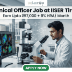 High-Paying Technical Officer Job at IISER Tirupati – Apply Before Deadline!. A professional recruitment graphic for a Technical Officer job at IISER Tirupati. The image features a focused male scientist in a modern, brightly lit laboratory environment, working with high-tech equipment and dual monitors displaying colorful microscopic cell images. At the top, the Biotecnika logo is positioned above bold text that reads: "Technical Officer Job at IISER Tirupati" with a tagline "Earn Upto ₹57,000 + 9% HRA/ Month." A prominent green "Apply Now" button is located at the bottom center.