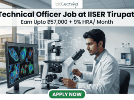 High-Paying Technical Officer Job at IISER Tirupati – Get Monthly Emoluments of ₹57,000 + 9% HRA High-Paying Technical Officer Job at IISER Tirupati – Apply Before Deadline!. A professional recruitment graphic for a Technical Officer job at IISER Tirupati. The image features a focused male scientist in a modern, brightly lit laboratory environment, working with high-tech equipment and dual monitors displaying colorful microscopic cell images. At the top, the Biotecnika logo is positioned above bold text that reads: "Technical Officer Job at IISER Tirupati" with a tagline "Earn Upto ₹57,000 + 9% HRA/ Month." A prominent green "Apply Now" button is located at the bottom center.