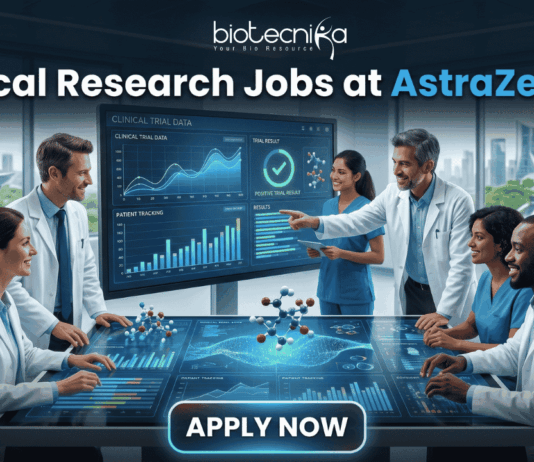 Hiring Now! Clinical Research Jobs at AstraZeneca for Life Science Graduates! A professional featured image for "Clinical Research Jobs at AstraZeneca." It shows a group of medical researchers in lab coats gathered around a large interactive touch-table displaying clinical trial data, graphs, and 3D molecular models. The Biotecnika logo is at the top, and a sleek "Apply Now" button is at the bottom.