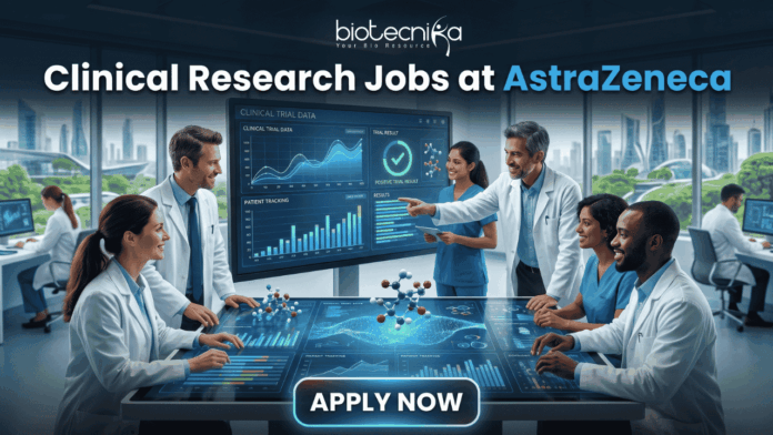 Hiring Now! Clinical Research Jobs at AstraZeneca for Life Science Graduates! Hiring Now! Clinical Research Jobs at AstraZeneca for Life Science Graduates! A professional featured image for "Clinical Research Jobs at AstraZeneca." It shows a group of medical researchers in lab coats gathered around a large interactive touch-table displaying clinical trial data, graphs, and 3D molecular models. The Biotecnika logo is at the top, and a sleek "Apply Now" button is at the bottom.