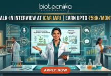 ICAR IARI Recruitment 2026: Walk-in Interview for Research Associate & SRF – Earn Upto ₹58,000/month ICAR IARI Recruitment Walk-in Interview - Earn Upto ₹58Kmonth. A featured job advertisement image for Biotecnika. At the top center, the Biotecnika logo with the text "biotecnika Your Bio Resource" is displayed. Below it, a main headline in gold and white text reads: "WALK-IN INTERVIEW AT ICAR IARI | EARN UPTO ₹58K/MONTH". A young female scientist of South Asian descent in a lab coat smiles and holds a tablet, presenting behind a futuristic desk with an advanced screen. Translucent blue holographic panels float around her, displaying graphs, a microphone icon, a DNA helix, and plant illustrations. Text on the panels includes "Communicating Ag-Biotech Innovations" and "Effective Presentation of Data". Other diverse scientists are working in the background laboratory environment. At the bottom center, a large red "APPLY NOW" button is prominent.