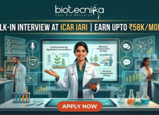 ICAR IARI Recruitment 2026: Walk-in Interview for Research Associate & SRF – Earn Upto ₹58,000/month ICAR IARI Recruitment Walk-in Interview - Earn Upto ₹58Kmonth. A featured job advertisement image for Biotecnika. At the top center, the Biotecnika logo with the text "biotecnika Your Bio Resource" is displayed. Below it, a main headline in gold and white text reads: "WALK-IN INTERVIEW AT ICAR IARI | EARN UPTO ₹58K/MONTH". A young female scientist of South Asian descent in a lab coat smiles and holds a tablet, presenting behind a futuristic desk with an advanced screen. Translucent blue holographic panels float around her, displaying graphs, a microphone icon, a DNA helix, and plant illustrations. Text on the panels includes "Communicating Ag-Biotech Innovations" and "Effective Presentation of Data". Other diverse scientists are working in the background laboratory environment. At the bottom center, a large red "APPLY NOW" button is prominent.