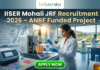Junior Research Fellow (JRF) at IISER Mohali | Apply Now. A professional promotional image for the IISER Mohali JRF Recruitment 2026. At the top, the Biotecnika logo is displayed above the bold headline: "IISER Mohali JRF Recruitment 2026 – ANRF Funded Project." The scene features a young Indian female scientist in a white lab coat and safety glasses, meticulously working with a sophisticated bioreactor containing an orange-tinted culture. The background shows a bright, modern research facility with other scientists at work and a large window overlooking a lush, green university campus. To the left, a whiteboard is covered in complex chemical equations and the words "JRF PROJECT 2026." A prominent, glowing green "APPLY NOW" button is centered at the bottom of the frame.