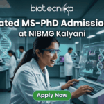 Integrated MS-PhD Admission 2026 at NIBMG Kalyani. A modern featured image for "Integrated MS-PhD Admission 2026 at NIBMG Kalyani." It shows a young scientist enthusiastically analyzing DNA sequencing data on a futuristic monitor in a genomics lab. Includes the Biotecnika logo and an "Apply Now" button.
