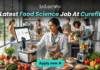 Latest Food Science Job At Curefit Apply For Nutritionist Role. A sleek, lifestyle-oriented featured image for "Latest Food Science Job At Curefit." It shows a food scientist in a modern culinary lab using smart kitchen technology like a sous-vide machine and a tablet dashboard. The Biotecnika logo is at the top, and a cyan "Apply now" button is at the bottom.