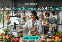 Latest Food Science Job At Curefit | Apply For Nutritionist Role Today! Latest Food Science Job At Curefit Apply For Nutritionist Role. A sleek, lifestyle-oriented featured image for "Latest Food Science Job At Curefit." It shows a food scientist in a modern culinary lab using smart kitchen technology like a sous-vide machine and a tablet dashboard. The Biotecnika logo is at the top, and a cyan "Apply now" button is at the bottom.