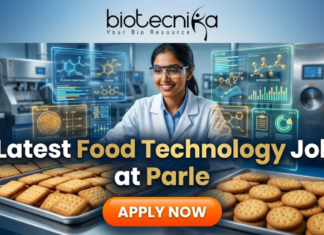 Latest Food Technology Job at Parle – BSc & BTech Graduates Apply Now! Latest Food Technology Job at Parle – BSc & BTech Graduates Apply Now. An advertisement featuring a smiling woman in a lab coat and safety glasses, working in a food production environment surrounded by futuristic holographic displays of "FLAVOR COMPOUNDS" and "NUTRIENT CHAINS." Large text reads "Latest Food Technology Job at Parle." At the top is the "biotecnika Your Bio Resource" logo, and a large "APPLY NOW" button is at the bottom. Trays of biscuits are on the counter.