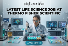 Latest Life Science Job at Thermo Fisher Scientific | Apply Before It Closes Latest Life Science Job at Thermo Fisher Scientific Apply Today. A professional and vibrant featured image for a "Latest Life Science Job at Thermo Fisher Scientific." The image showcases a scientist in a white lab coat and safety goggles, precisely working with a multichannel pipette and a multi-well plate filled with glowing blue and green liquids. The background is a futuristic, high-tech laboratory with advanced bioreactors and computer screens displaying molecular structures. The Biotecnika logo is featured at the top, the main job title is in bold black text in the center, and a sleek teal "APPLY NOW" button is positioned at the bottom.