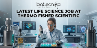 Latest Life Science Job at Thermo Fisher Scientific Apply Today. A professional and vibrant featured image for a "Latest Life Science Job at Thermo Fisher Scientific." The image showcases a scientist in a white lab coat and safety goggles, precisely working with a multichannel pipette and a multi-well plate filled with glowing blue and green liquids. The background is a futuristic, high-tech laboratory with advanced bioreactors and computer screens displaying molecular structures. The Biotecnika logo is featured at the top, the main job title is in bold black text in the center, and a sleek teal "APPLY NOW" button is positioned at the bottom.
