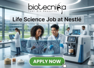 Dream Life Science Job at Nestlé | BSc Candidates Apply Before Deadline! Life Science Job at Nestlé Nutrition Officer Role. A professional featured image titled "Life Science Job at Nestlé". The image showcases the Biotecnika logo at the top and a vibrant green "APPLY NOW" button at the bottom. The background depicts a bright, high-tech laboratory where two scientists—a woman and a man—are smiling and collaborating over a futuristic holographic display of molecular structures. Other researchers and advanced laboratory equipment are visible in the sleek, modern setting.