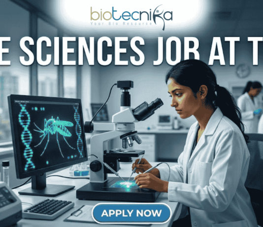 Life Sciences Job at TIGS Research Scientist & Support Roles. A professional featured image (1280x720) for a Life Sciences Job at TIGS. The scene depicts a modern, high-tech laboratory where a female scientist of South Asian descent is meticulously working with a microscope. To her left, a large computer monitor displays a glowing green digital 3D model of a mosquito overlaid with a DNA double helix, signifying genetic research. The Biotecnika logo is prominently placed at the top center. The text "LIFE SCIENCES JOB AT TIGS" is written in bold, white capital letters across the top. At the bottom center, there is a sleek, blue "APPLY NOW" button. The background shows a bright, clean research facility with other scientists in lab coats, creating an atmosphere of innovation and discovery.