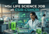 MSc Life Science Job at CSIR-CSMCRI Apply For JRF Role Today!! A unique featured image for "MSc Life Science Job at CSIR-CSMCRI." It depicts a scientist in a specialized lab focusing on marine biotechnology, with bioreactors containing green algae in the foreground and a view of salt pans at sunset through the window. The Biotecnika logo is at the top, and a green "Apply Now" button is at the bottom.