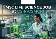 MSc Life Science Job at CSIR-CSMCRI Apply For JRF Role Today!! A unique featured image for "MSc Life Science Job at CSIR-CSMCRI." It depicts a scientist in a specialized lab focusing on marine biotechnology, with bioreactors containing green algae in the foreground and a view of salt pans at sunset through the window. The Biotecnika logo is at the top, and a green "Apply Now" button is at the bottom.
