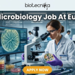 MSc Microbiology Job Alert: Eurofins Hiring Research Scientists in Bengaluru – Apply Now! MSc Microbiology Job Alert Eurofins Hiring Research Scientists in Bengaluru – Apply Now! A high-quality, professional featured image for an "MSc Microbiology Job At Eurofins." The image features a female microbiologist in a white lab coat and purple gloves, carefully examining a petri dish containing a microbial culture. She is working at a modern lab bench equipped with a high-end microscope and a computer monitor displaying a digital analysis of a bacterial colony. The laboratory background is clean and advanced, with signs indicating "ISO 17025 ACCREDITED." The Biotecnika logo is prominent at the top center, the main job title is displayed in bold white text, and a vibrant orange "APPLY NOW" button is positioned at the bottom.