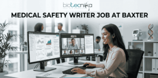 Medical Safety Writer Job at Baxter – High Demand Life Science Role in Ahmedabad! A sleek, realistic featured image for a career opportunity. The Biotecnika logo is at the top. The bold heading "MEDICAL SAFETY WRITER JOB AT BAXTER" spans the upper section. The image depicts a female professional sitting at a clean, modern desk with dual monitors; one screen shows data charts and the other shows a video conference with colleagues. The setting is a bright, contemporary office with a DNA model in the background. A blue and teal gradient "APPLY NOW" button is located at the bottom center.