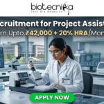 NIPER Recruitment for Project Assistant Role | Earn Upto ₹42,000 + 20% HRA/Month – Apply Now! NIPER Recruitment for Project Assistant Role | Earn Upto ₹42,000. A scientist using an automated liquid handling system in a modern research facility. Header: "NIPER Recruitment for Project Assistant Role" with the HRA salary tagline. Biotecnika logo at top, green "Apply Now" button.